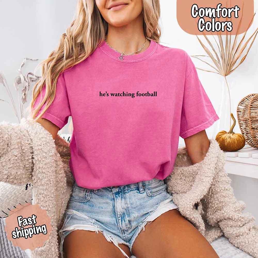 He’s Watching Football Tee - Comfort Colors Funny Shirt for Her